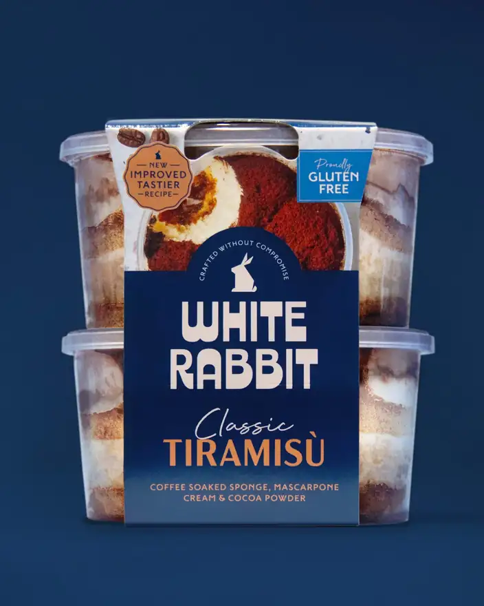 Two tubs of White Rabbit Classic Tiramis\u00f9 stacked on navy