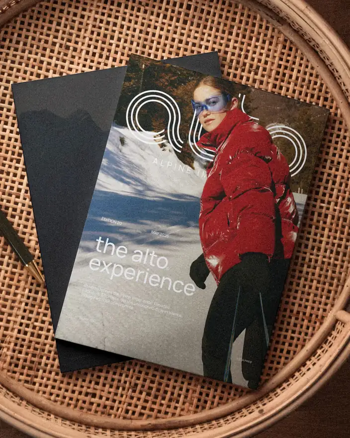 The Alto magazine on a rattan tray, cover showing a skier in a red jacket behind the outlined wordmark